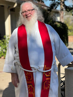 Photo of Vicar David wearing a red stole